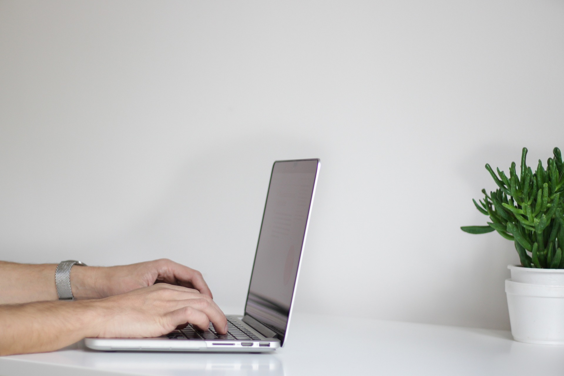 hands working on a laptop