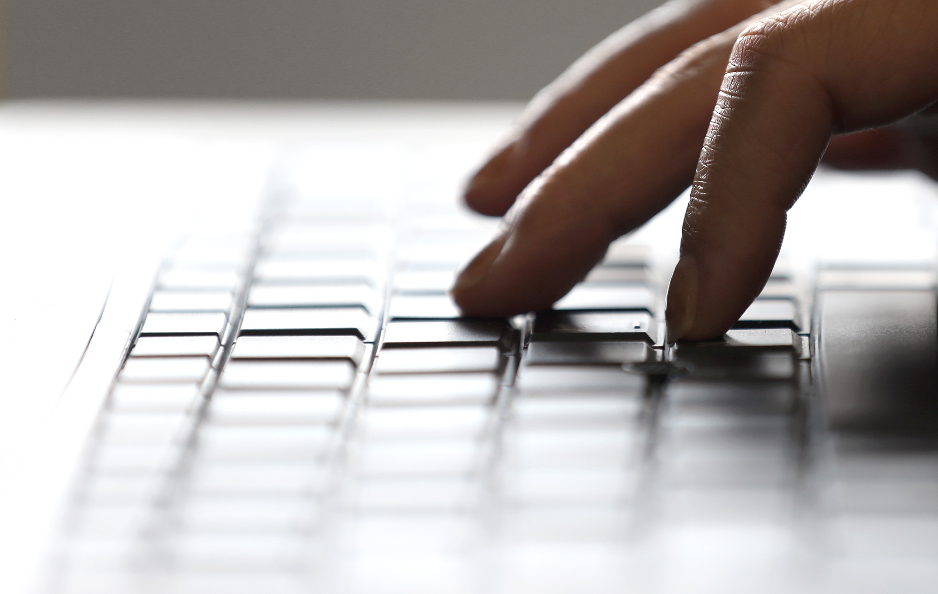 hand writing on a keyboard